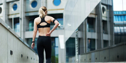 a person in exercise gear walking towards a building