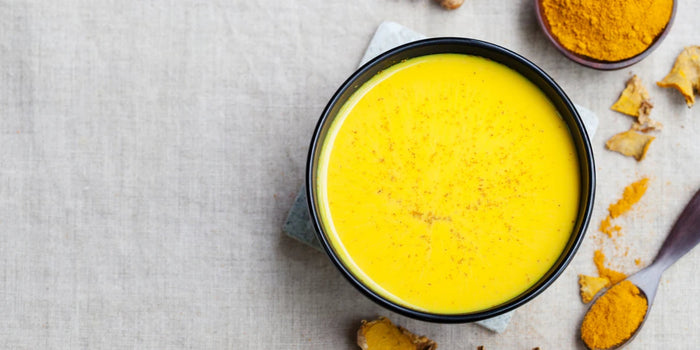 a bowl of vibrant yellow turmeric soup