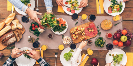 people gathered around a table, enjoying a meal